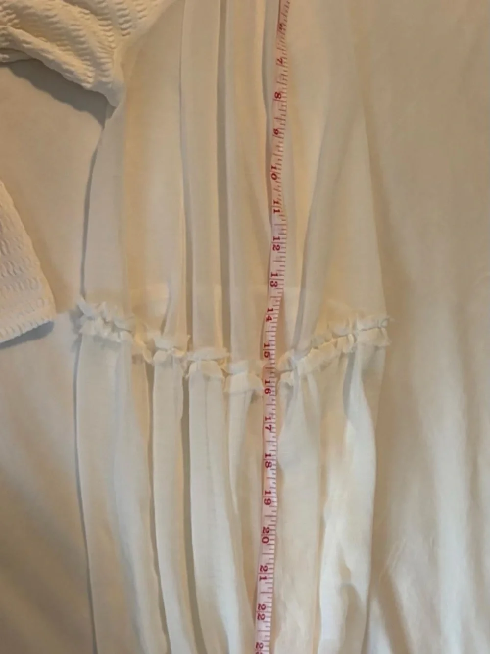 White flowy long sleeve top with ruffle detail